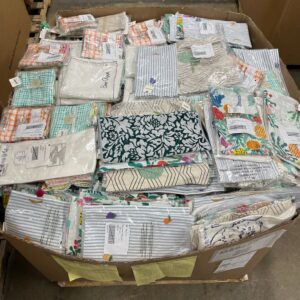 Pile of new, colorful bulk dish towels on a pallet, ready for liquidation sale