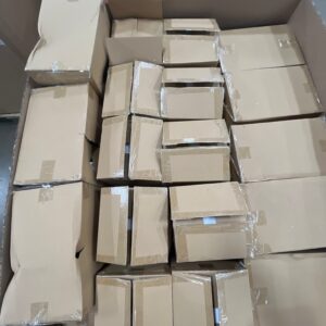 A pallet filled with new name-brand large white floral vases, perfect for wholesale floral vases inventory.