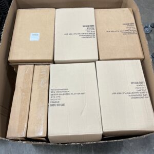 Large white wholesale table platters on a pallet, ready for bulk purchase.