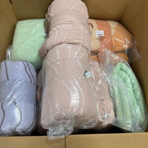 Assorted new name-brand wholesale comforters in various colors and styles on a pallet.