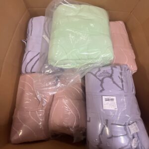 A vibrant assortment of new, name-brand wholesale comforter pallets in various colors and styles, stacked for shipping.