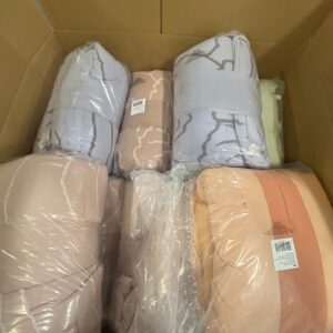 Assorted new name-brand wholesale comforters in various colors and styles, 92% off retail, on a liquidation pallet.