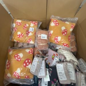 Assorted new name-brand items in wholesale bedding pallets, including duvet covers and sheets.