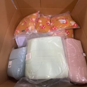 A diverse collection of new name-brand bedding, neatly stacked within wholesale bedding pallets.