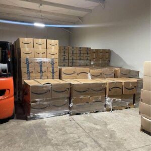 A stack of colorful Amazon mystery boxes, ready for bulk liquidation sales, filled with unknown treasures.