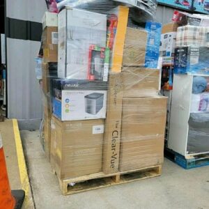 A stack of mixed merchandise pallets filled with diverse, brand new products for resale.