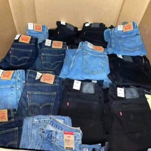 A large pallet stacked high with various styles of Levi's wholesale denim jeans, all with tags.