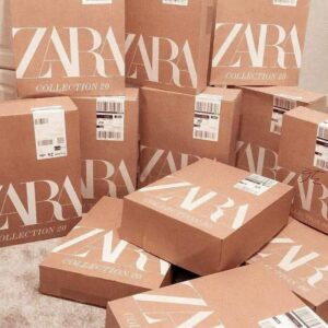 A large Zara clothing pallet filled with new jeans and various apparel, all with tags