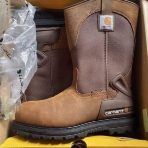 A large Carhartt boots pallet stacked with 200 brand-new pairs in various sizes and colors.