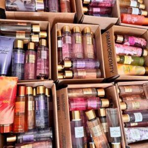 A large pallet stacked high with various Victoria's Secret cream spray lotions