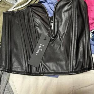 A large pallet filled with assorted Lulus apparel, including tops, jackets, and skirts, all new with tags, showcasing the variety of Lulus apparel pallets.