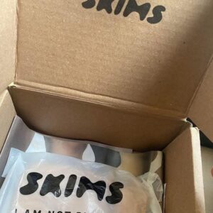 Skims wholesale pallet with 300 brand new Skims clothing items, neatly stacked for resale.