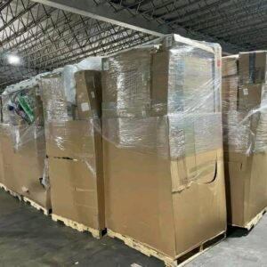 Towering Amazon monster pallet filled with appliances, electronics, furniture, and diverse liquidation goods.