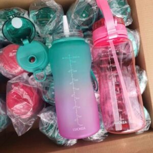 A pallet of 64 oz Motivation Bulk Water Bottles with straws and locking tops.