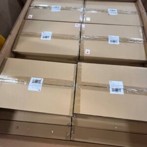 A stack of new, name-brand white floral wholesale large table platters with elegant designs.
