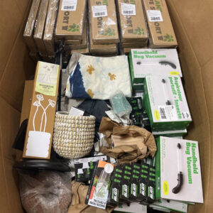 A diverse pallet filled with new wholesale garden products, including planters and watering tools.