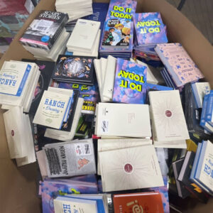 Large pallet filled with assorted new books, including novels, journals, and cookbooks, from books liquidation pallets