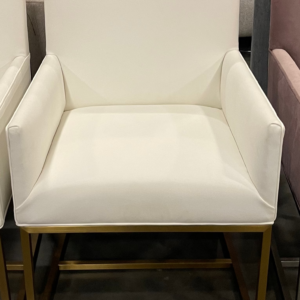 A sleek Mitchell Gold + Bob Williams vegan leather armchair with elegant wooden legs
