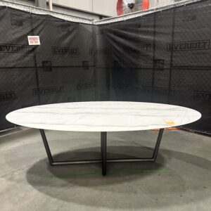 Elegant Mitchell Gold + Bob Williams modern oval dining table with sleek lines and sturdy base, perfect for luxury dining.