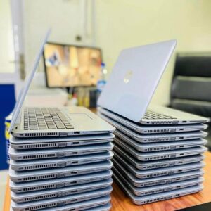 A pallet stacked with boxes containing Dell HP laptop pallets and chargers, ready for wholesale.