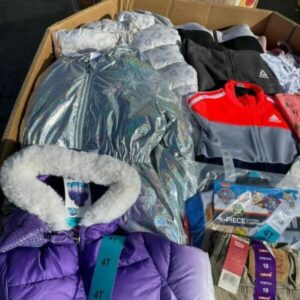 Large kids clothes pallets packed with new children's apparel, including jeans, shirts, and outerwear.