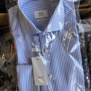 Pallet of assorted wholesale men's shirts, neatly stacked and ready for bulk shipping.