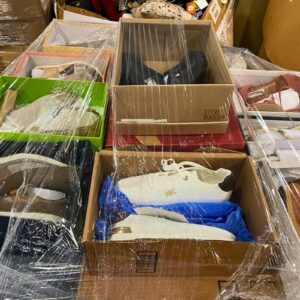 A diverse collection of wholesale shoe pallets featuring assorted brands, styles, and sizes of footwear.