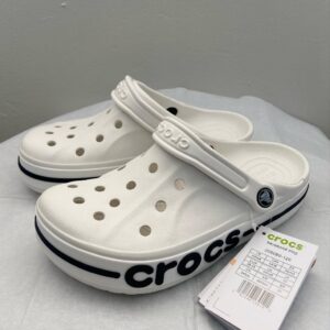 Large Crocs liquidation pallet filled with various styles and colors of bulk Crocs shoes