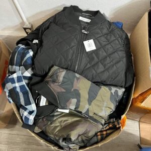 A diverse winter jacket pallet featuring approximately 100 brand new assorted jackets for men, women, and children.