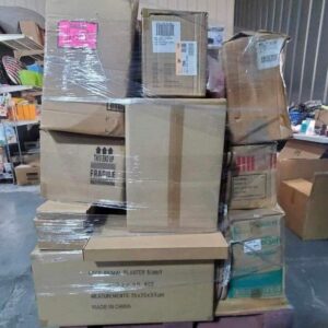 A large bulk christmas clothes pallet filled with colorful holiday sweaters, pajamas, and scarves.