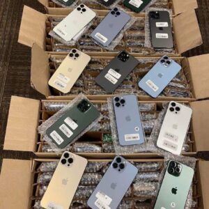 A neatly stacked wholesale iPhone liquidation pallet with various iPhone models in boxes.