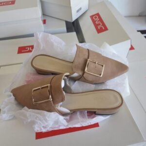 A large pallet stacked with numerous boxes of brand new wholesale women's shoes and sandals.