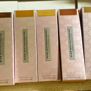 A stack of wholesale foundation pallets featuring XX Revolution Glow Skin Fauxxdation bottles.